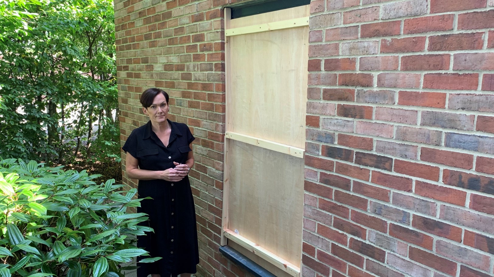 Sarah Sasmazer, who is in charge of Haven Court, with the window boarded up following the break in at the home..jpg